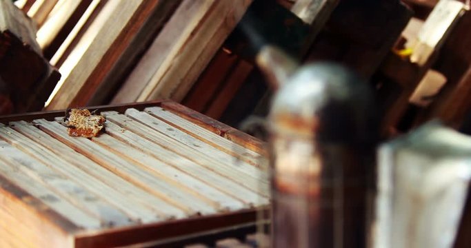 Close-up of beehive box and smoker