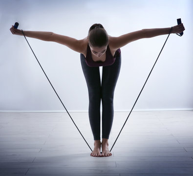 Young Woman Training With Skipping Rope At Home