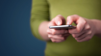 Young woman holding smarthphone in hand