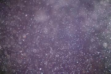 Snowfall texture of snowflakes on blurred background