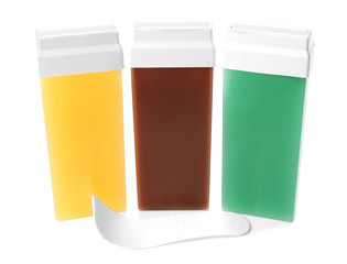 Liposoluble wax cartridges and spatula on white background