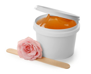 Plastic bucket with sugaring paste, stick and flower on white background