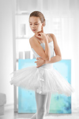 Fototapeta premium Young beautiful ballerina standing in her room at home