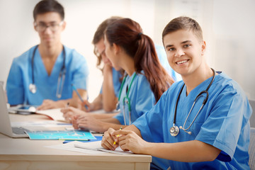 Group of medical students having lecture indoors