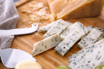 Sliced cheese with herbs, closeup