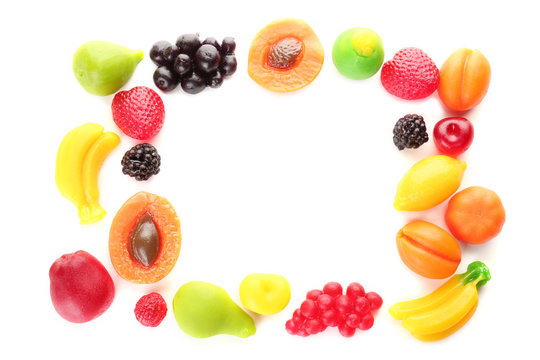 Frame made of fruit jelly candies on white background