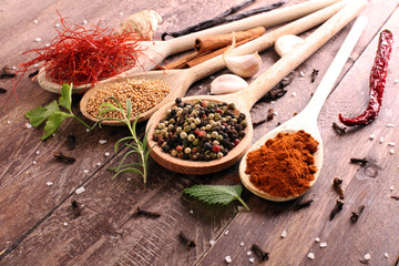 Various colorful spices on wooden table