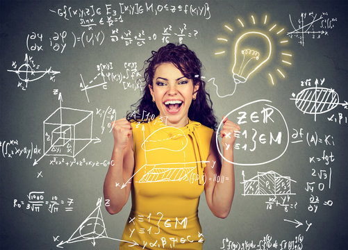 excited student with idea light bulb and maths and science formulas on blackboard