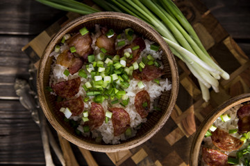 Rice with bacon and green onions. Nourishing lunch for two in clay dishes