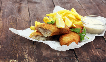 traditional British fish and chips on wooden background