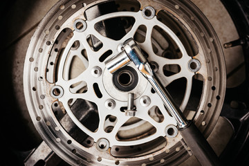 Metal wrench on motorcycle disk brake