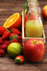 several bottles with fruit and berry juices smoothies and milksh