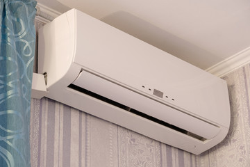 Air conditioner hangs on a wall