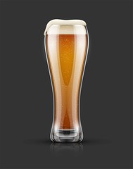 Full glass of light lager beer with froth on top. Isolated dark