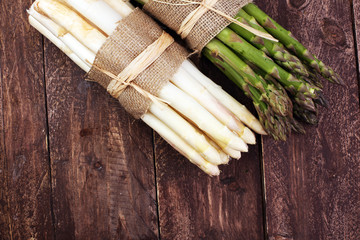 Bunch of fresh white asparagus and green asparagus on table