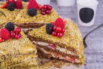 Pistachio cake with fresh berries, raspberry and red currant