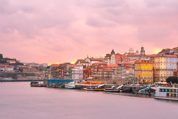 Fototapeta na wymiar Ribeira and Old town of Porto with mirror reflections in the Douro River at sunset, Portugal, Portugal.