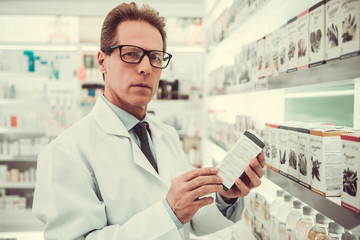 Fototapeta premium Handsome pharmacist working