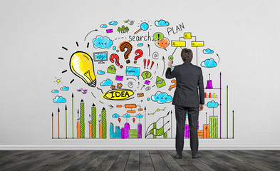 Businessman drawing bright business idea