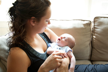Mother smiles at her newborn