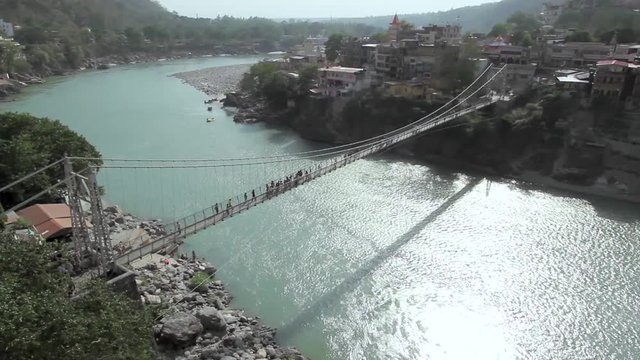 A shot of Lakshman Jhula iron suspension bridge across the River Ganges in the holy city of Rishikesh, North India.