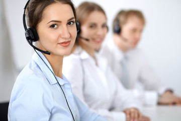 Call center. Focus on beautiful business  woman in headset.