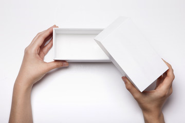 woman hand hold a white empty small box isolated white.