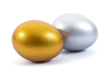 Gold and silver eggs isolated on white background.Silver and gold eggs isolated