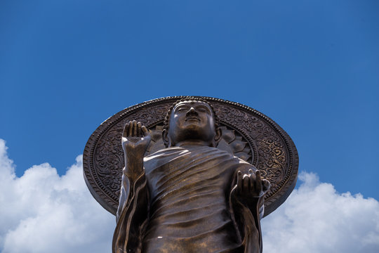 Front of Bronze stand buddha statue, worm eye view