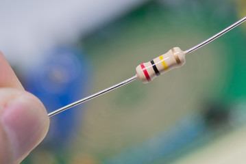 Closeup 200K or 200,000 Ohms resistors against electronic board.