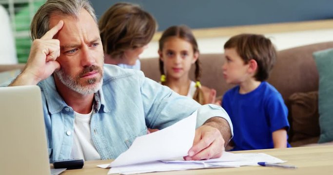 Worried man calculating bills
