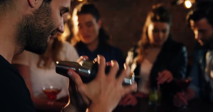Bartender preparing cocktail at bar counter