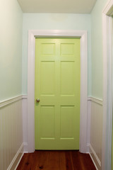 Interior hallway with green door
