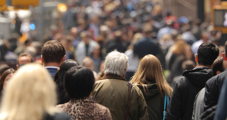 Crowd of people walking street in city