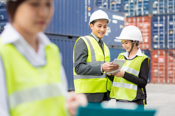 Asian businessman and Asian secretary  working with container Cargo freight ship in shipyard for Logistic Import Export background