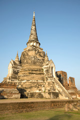 Fototapeta premium One of the three ancient stupas of the Buddhist temple Wat Phra Si Sanphet in the rays of the setting sun. Ayutthaya, Thailand