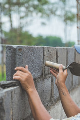 installing cement bricks on construction site