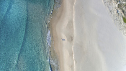 Aerial view of beach ocean waves and people walking on sand on Gold Coast beach