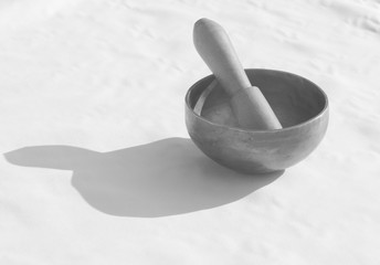 Tibetan singing bowl on a wooden table. black and white photo.