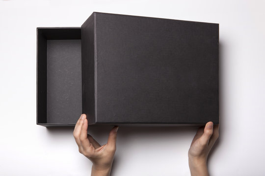 Woman Hand Hold A Black Box Isolated White.