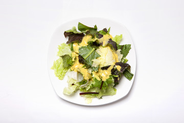 salad with white dish isolated white.