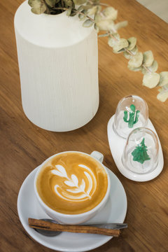 Coffee With Latte Art On Wooden Table