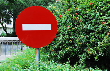 No entry sign in front of  metal fence