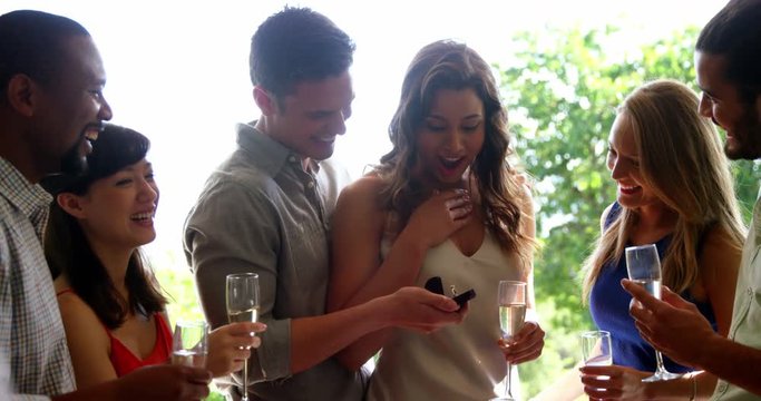 Man proposing to woman offering engagement ring