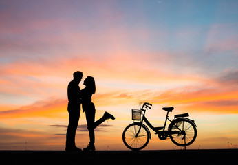 Fototapeta na wymiar Silhouette young couple in love enjoy good time together during sunset.