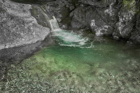 Crystalline waterfall in Val Vertova and gray rocks