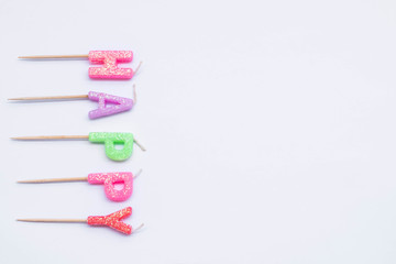 Colorful candles in letters Happy Birthday,background