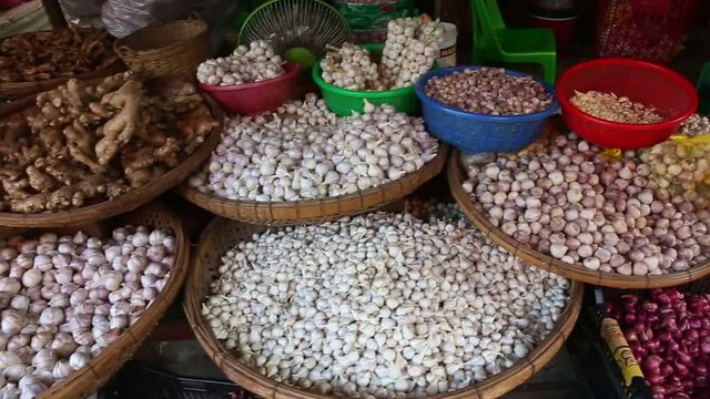 Close-up of big baskets with garlic and onions.