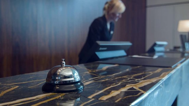 Service bell standing on marble reception desk