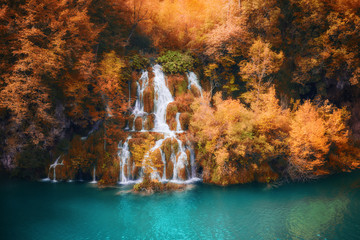 Fototapeta na wymiar Beautiful fall colors forest waterfall